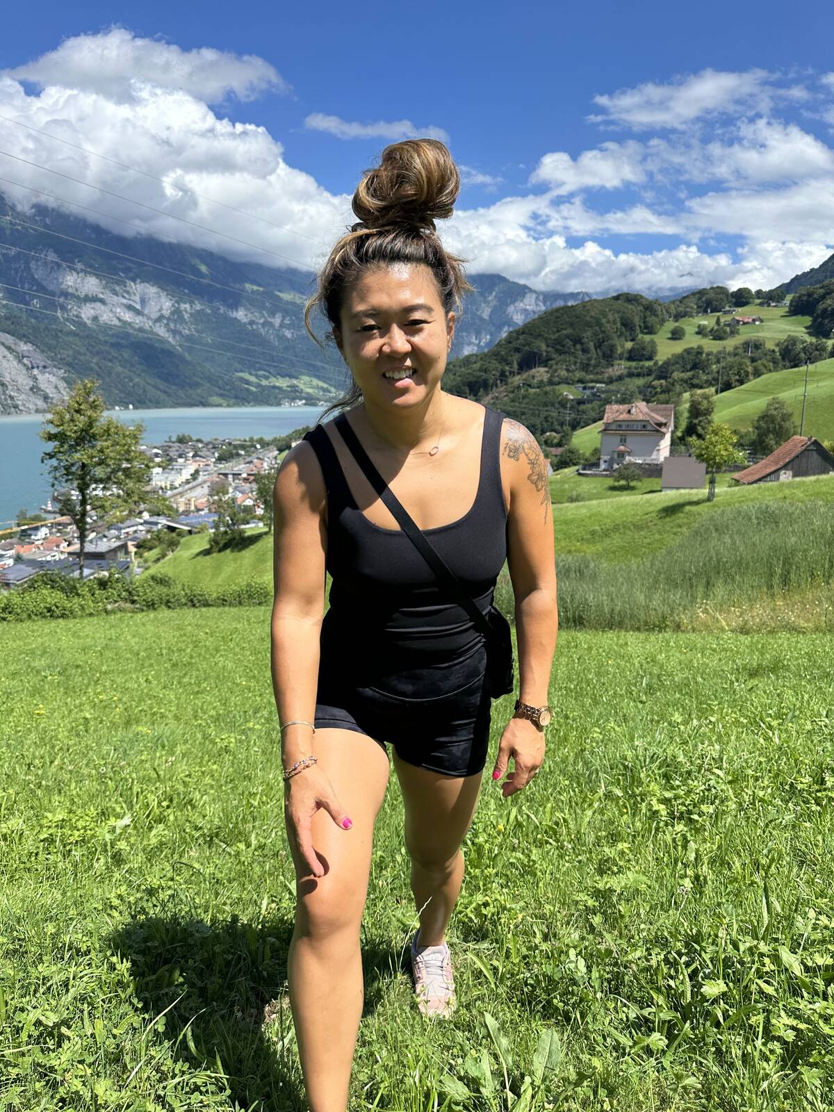 Sunny, smiling, on a hike through a green alpine meadow